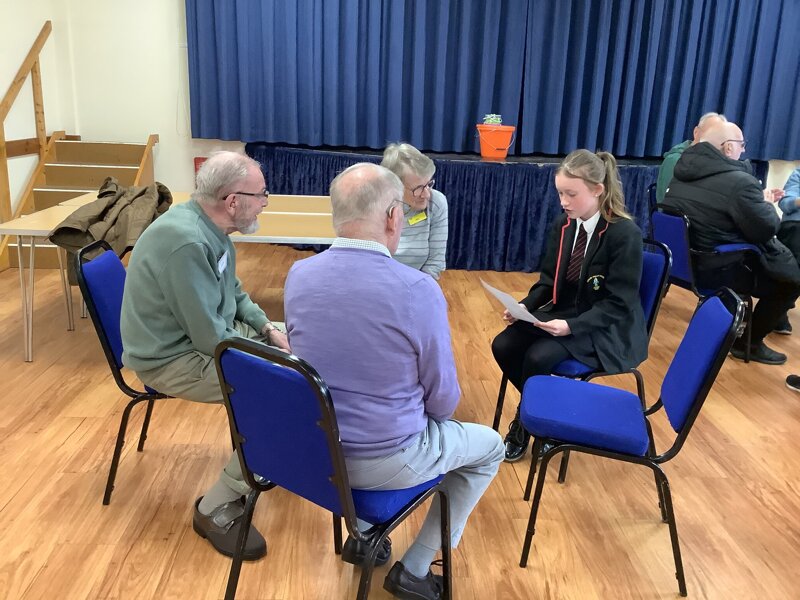 Image of Reading at the village hall with Dementia Caring Charity